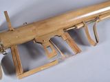 a wooden toy gun that is on display on a table
