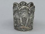 a silver cup that has a design on it