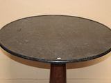 a small table with a marble top and wooden legs