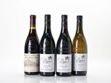 three bottles of wine are lined up on a white surface