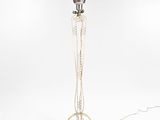 a white floor lamp with a metal base and a metal shade