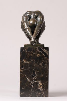 an image of a sculpture of a man sitting on top of a marble block
