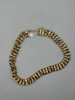 a gold chain bracelet with a diamond clasp