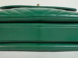 green leather handbag with chain strap on white background