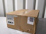 an empty box sitting on top of a table next to a white wall