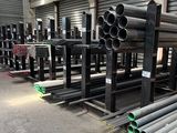 pipes and tubes are stacked up in a warehouse for sale