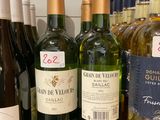 several bottles of wine are lined up on a counter