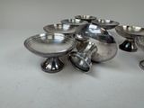 a group of silver bowls sitting on a table