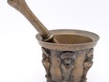 an old mortar with a wooden pestula in it on a white background