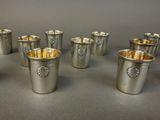 six silver cups are lined up in a row on a table