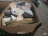 a box full of clothes and a hat on a table