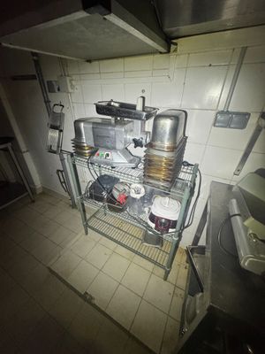 an image of a kitchen with pots and pans on a rack