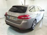 the rear end of a silver car parked in a garage