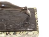 statue of a woman laying down on a marble block with a white background