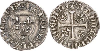 a silver coin with a cross on the front and a shield on the back