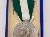 a close up of a medal in a blue box on a table