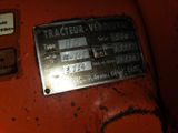 a close up of a metal plate on a red machine