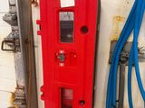 a red machine that is next to a blue hose