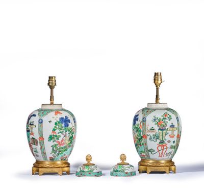 two chinese vases and a table lamp on a white surface