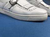 a close up of a pair of white shoes on a blue surface