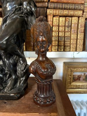 a bronze statue of a woman holding a child