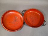 pair of red ceramic bowls with handles and handles