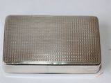 an old silver cigarette case sitting on top of a white table