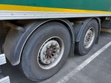 a green and yellow truck that is parked in a parking lot
