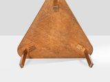 an image of a wooden triangle shaped object on a white surface