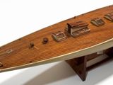 a wooden model of a boat on display on a table