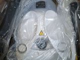 a box with a baby car seat in it that is wrapped in plastic