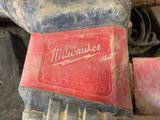 a red milwaukee logo on the side of a red tool