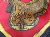 a close up of a red and gold scarf with a dragon on it