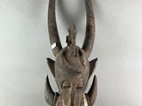 statue of a horned head with horns on a white background