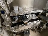 a kitchen that has a bunch of pans inside of it