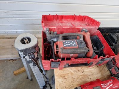 a red box with tools in it sitting on the floor