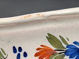 a close up of a bowl with a flower design on it