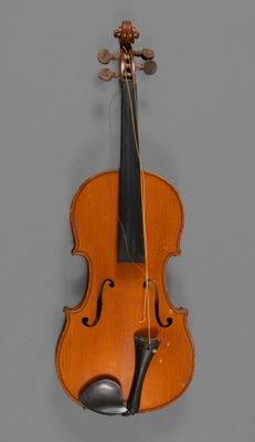 an old violin with a bow hanging on a wall