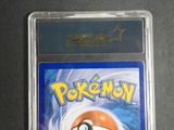a close up of a pokemon card in a plastic case