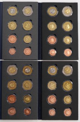 a group of six different colored coins in a black box
