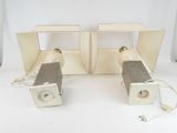 two speakers sitting next to each other on a white surface