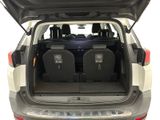 two seats in the back of a car with the trunk open