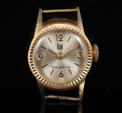 an image of a close up of a gold watch on a black surface