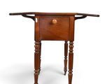 an old wooden table with a drawer on top of it
