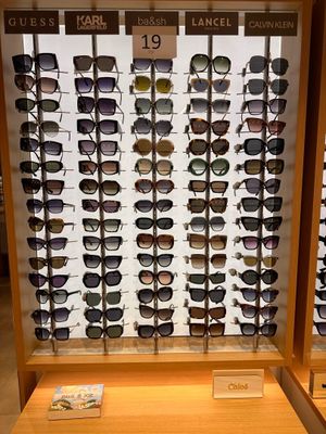 many pairs of sunglasses on display in a display case