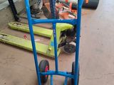 a blue hand truck with a blue handle in a warehouse
