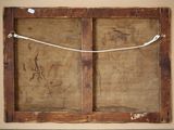 an old wooden frame with a wire and a piece of paper hanging from it