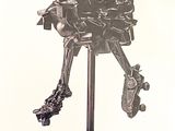 a metal sculpture of a robot on a stand