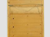 a wooden mirror hanging on the wall with a rope