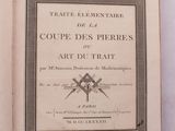 un livre ouvert sur lequel est posée l'image d'une paire de ciseaux